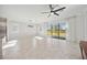 Bright living room featuring tile floors, neutral walls, and an oversized sliding glass door at 11165 Balfour St, Venice, FL 34293