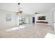 Open living room with large windows, tile flooring, modern lighting, and accent wall at 11165 Balfour St, Venice, FL 34293