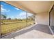 Screened lanai with stone flooring, offering an outdoor living space with serene views of the backyard at 11165 Balfour St, Venice, FL 34293