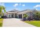 Charming exterior view of a well-maintained home, featuring a three-car garage and nice landscaping at 1216 Thornbury Dr, Parrish, FL 34219