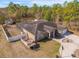 Aerial view of a single-Gathering home with a screened pool, fenced yard, basketball court, and detached storage shed at 13040 Quigley Ave, Weeki Wachee, FL 34614