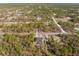 Aerial view of a home nestled among trees in a residential community at 13040 Quigley Ave, Weeki Wachee, FL 34614
