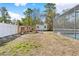 Expansive backyard featuring a chicken coop and screened-in pool area at 13040 Quigley Ave, Weeki Wachee, FL 34614