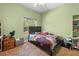 Comfortable bedroom with a bed, natural light from the window, and neutral tones at 13040 Quigley Ave, Weeki Wachee, FL 34614