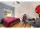 Bright bedroom with natural light from a window and wood floors at 13040 Quigley Ave, Weeki Wachee, FL 34614