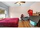 Spacious bedroom with hardwood floors, natural light, and ceiling fan fixture at 13040 Quigley Ave, Weeki Wachee, FL 34614
