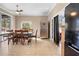 The dining area features neutral paint, tile flooring, and a large table, adjacent to the kitchen at 13040 Quigley Ave, Weeki Wachee, FL 34614