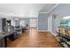 Open-concept living area with hardwood flooring offers a seamless flow and comfortable seating at 13040 Quigley Ave, Weeki Wachee, FL 34614