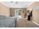 Bright bedroom with carpet flooring has sliding glass doors to the pool area at 13040 Quigley Ave, Weeki Wachee, FL 34614