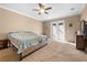 Comfortable bedroom with carpet boasts a ceiling fan and access to outdoor living space at 13040 Quigley Ave, Weeki Wachee, FL 34614
