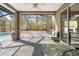 Spacious screened-in patio with comfortable seating, perfect for outdoor relaxation and entertaining at 13040 Quigley Ave, Weeki Wachee, FL 34614