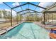 Inviting pool with a screened enclosure offers a refreshing retreat for relaxation and recreation at 13040 Quigley Ave, Weeki Wachee, FL 34614