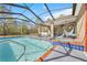 Beautiful in-ground pool with a spa, surrounded by a screened enclosure at 13040 Quigley Ave, Weeki Wachee, FL 34614