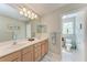 Double vanity bathroom with neutral color scheme, and a view of the commode at 14530 17Th E Ave, Bradenton, FL 34212