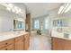 Bright main bathroom with double vanities, a soaking tub, and natural light at 14530 17Th E Ave, Bradenton, FL 34212