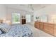 Bright bedroom with two windows, a ceiling fan and wood furniture at 14530 17Th E Ave, Bradenton, FL 34212