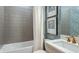 Inviting bathroom featuring subway tile, a bathtub, and elegant fixtures, creating a soothing space at 14919 Contenta Loop, Bradenton, FL 34211