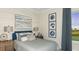 Cozy bedroom with stylish decor, including shiplap accent wall and a window view of golf course at 14919 Contenta Loop, Bradenton, FL 34211