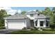 Beautiful single-Gathering home featuring a pristine white exterior, well-manicured landscaping, and an attached two-car garage at 14919 Contenta Loop, Bradenton, FL 34211