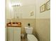 Cozy powder room with brick-style tiles, a pedestal sink, and decorative wall art at 150 Medici Ter, North Venice, FL 34275
