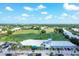 Aerial view showcasing Waterford Golf Course, lush greenery, and meticulously designed clubhouse at 1511 Waterford Dr, Venice, FL 34292