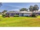 Lush, green backyard features a covered pool and patio area, perfect for outdoor entertaining at 1511 Waterford Dr, Venice, FL 34292