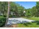 Outdoor basketball court surrounded by lush landscaping and mature trees offering a recreational amenity at 1511 Waterford Dr, Venice, FL 34292