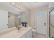 Bathroom with sliding glass shower, vanity, and floral wallpaper at 1511 Waterford Dr, Venice, FL 34292