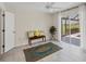 Bedroom featuring view of outdoors through sliding glass doors and neutral tile flooring at 1511 Waterford Dr, Venice, FL 34292