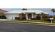 Charming single-story home featuring a well-manicured lawn and an inviting front entrance at 1511 Waterford Dr, Venice, FL 34292