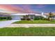 Charming single-story home featuring a lush green lawn and meticulously maintained landscaping at 1511 Waterford Dr, Venice, FL 34292