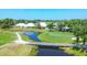 Scenic view of the golf course with lush green fairways, a pond, and a wooden bridge at 1511 Waterford Dr, Venice, FL 34292