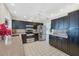 Well-equipped kitchen with black cabinetry, stainless steel appliances, and tile flooring at 1511 Waterford Dr, Venice, FL 34292