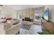 Bright living room features a unique stone fireplace, tile floors, and neutral decor at 1511 Waterford Dr, Venice, FL 34292