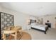 Bright main bedroom featuring decorative screen, king bed, and en suite bathroom at 1511 Waterford Dr, Venice, FL 34292