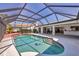 Inviting pool with a dolphin mosaic, spacious patio, and a screened enclosure for outdoor relaxation at 1511 Waterford Dr, Venice, FL 34292