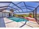 Sparkling pool inside screened lanai with a peaceful view of the lake and manicured landscaping at 1511 Waterford Dr, Venice, FL 34292