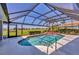 Screened-in pool with clear blue water, golf course views and outdoor living space at 1511 Waterford Dr, Venice, FL 34292