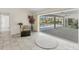 Light-filled sun room with view of pool through sliding glass doors to enclosed lanai at 1511 Waterford Dr, Venice, FL 34292