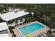 Aerial view of a large community pool with lounge chairs and meticulously maintained landscaping at 1511 Waterford Dr, Venice, FL 34292