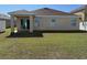 Large backyard featuring a covered patio and sliding glass doors at 15517 Rose Grove Dr, Bradenton, FL 34212