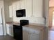Functional kitchen with white cabinets and modern black oven range and microwave at 15517 Rose Grove Dr, Bradenton, FL 34212