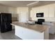 Open kitchen featuring an island with a sink and modern black appliances at 15517 Rose Grove Dr, Bradenton, FL 34212