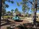 A charming playground with various play equipment sits under the shade of trees at 15517 Rose Grove Dr, Bradenton, FL 34212