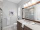 Bathroom featuring marble floors, a large framed mirror and a glass shower at 16407 Daysailor Trl, Lakewood Ranch, FL 34202