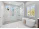 Bright bathroom features soaking tub, glass shower, and mosaic tile floor at 16407 Daysailor Trl, Lakewood Ranch, FL 34202