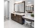 Bathroom featuring dual vanity sinks, makeup vanity, and white marble floors at 16407 Daysailor Trl, Lakewood Ranch, FL 34202
