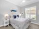 Bedroom features white metal bed frame, blue whale decor, and nautical theme at 16407 Daysailor Trl, Lakewood Ranch, FL 34202
