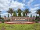 Beautiful stone and brick entrance to The Lake Club community with decorative fountain and lush landscaping at 16407 Daysailor Trl, Lakewood Ranch, FL 34202