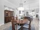 Elegant dining area featuring a wooden table, stylish chairs, and sophisticated decor at 16407 Daysailor Trl, Lakewood Ranch, FL 34202